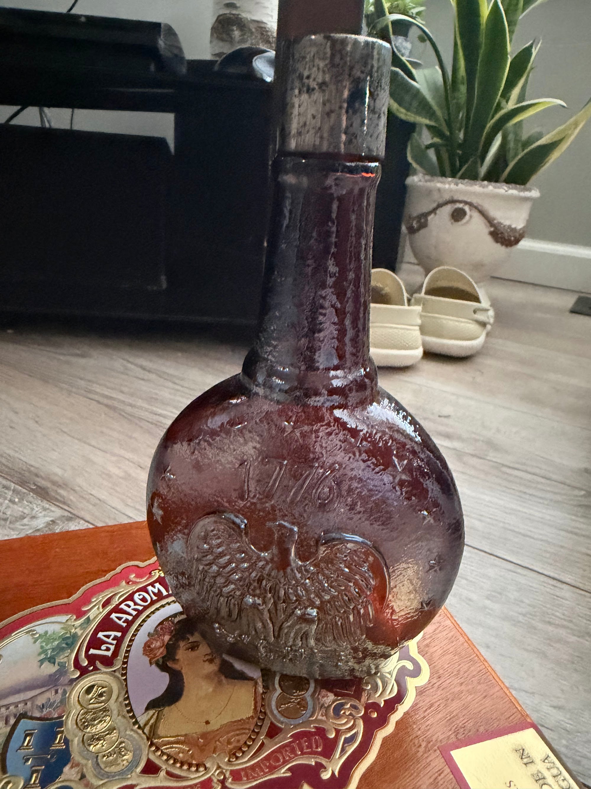 Side view showing bottle neck and metal cap