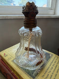 Antique miniature clear glass oil lamp with brass burner and wick, front view