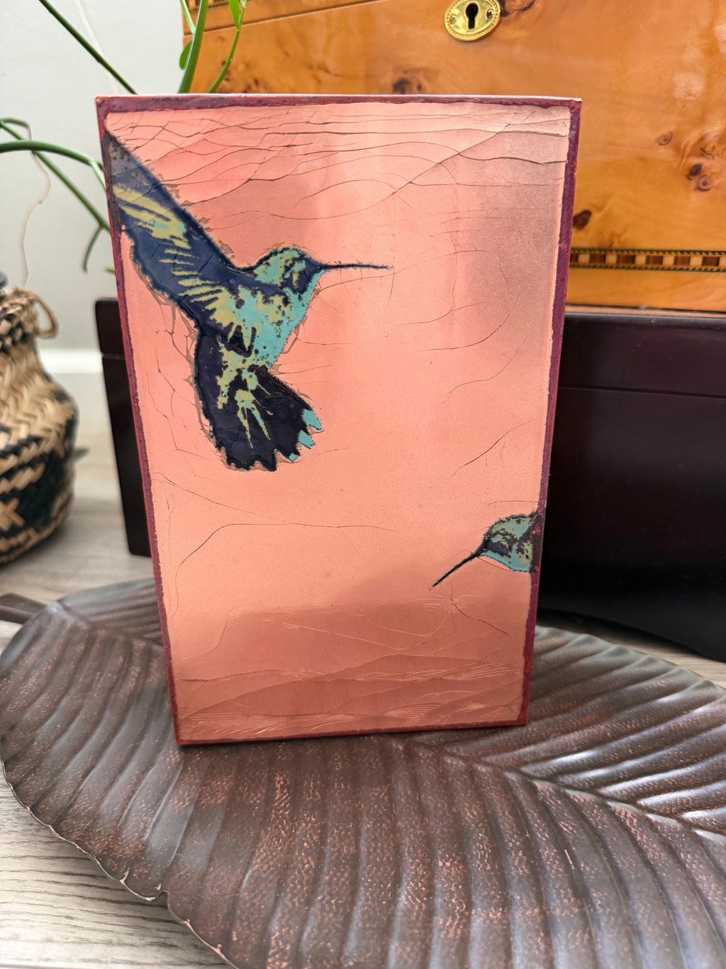 Front view of copper-toned Spiritile with two hummingbirds