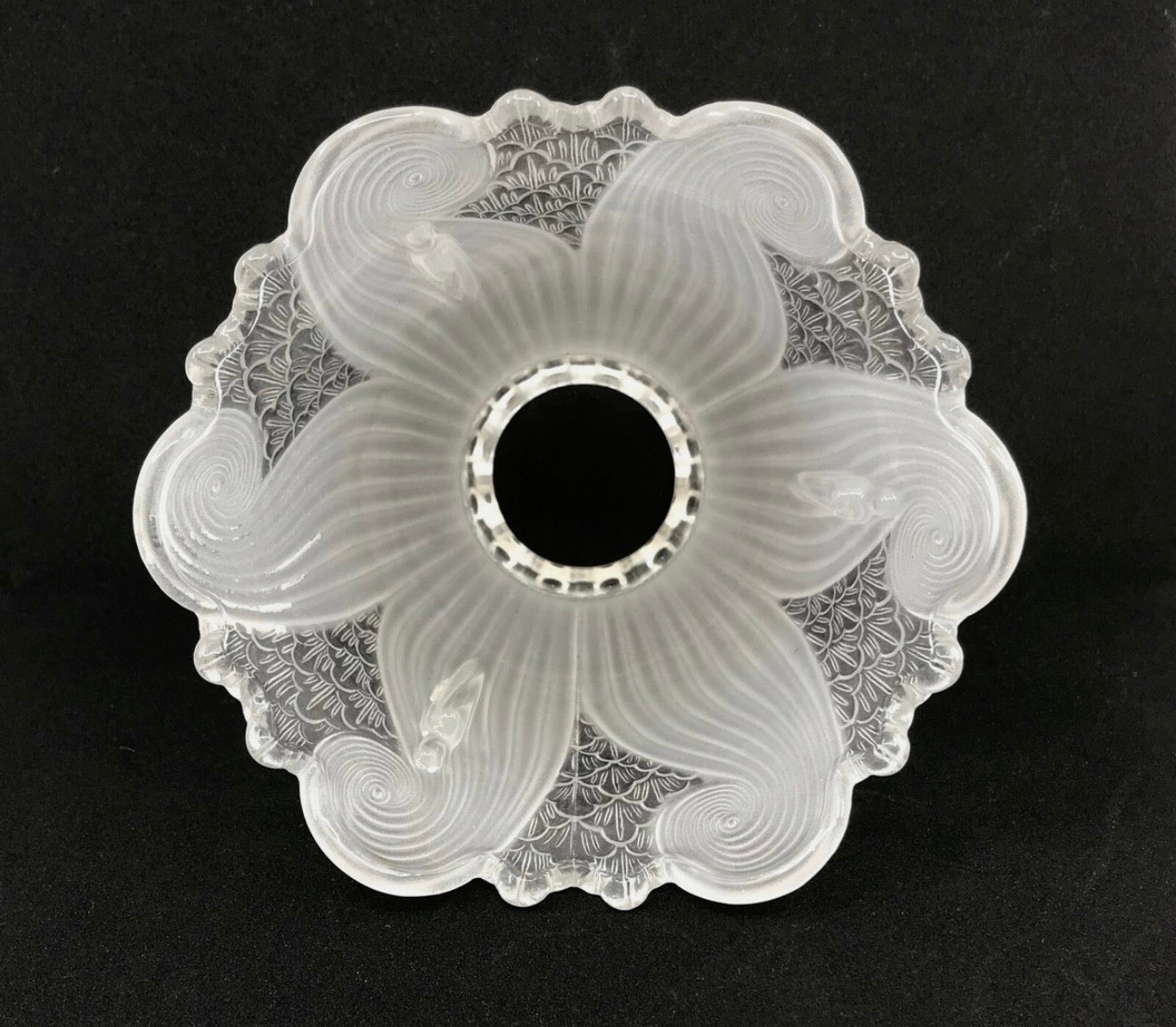 Top-down view of frosted swirl glass shade showing pinwheel pattern