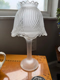 Frosted satin glass candle lamp assembled with swirl shell shade on pedestal base