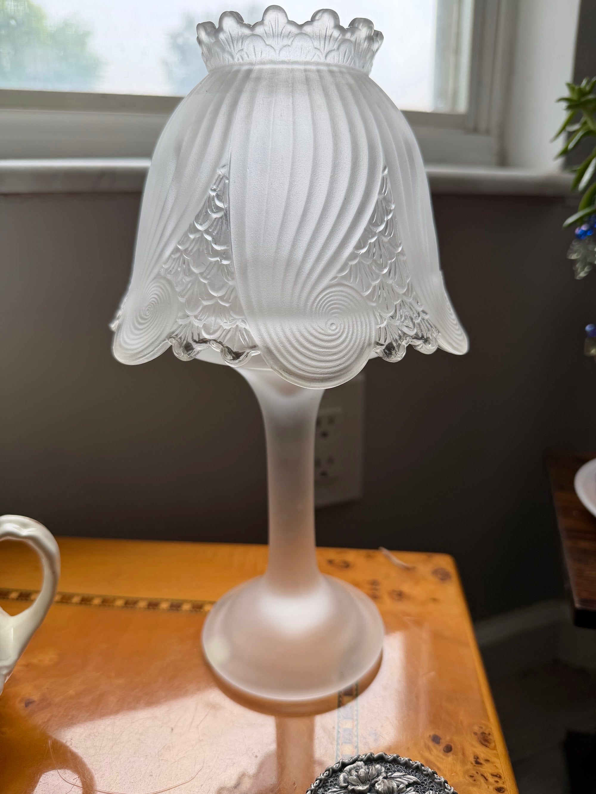 Frosted satin glass candle lamp assembled with swirl shell shade on pedestal base