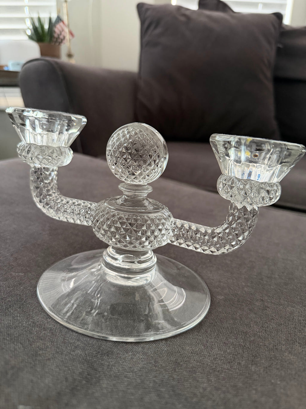 Two-light glass candelabra on neutral background